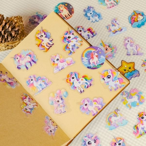 Close-up of colorful cartoon unicorn PET stickers on a notebook for DIY craft projects