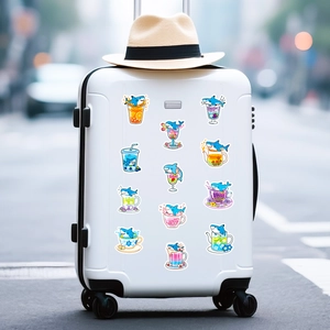 Waterproof shark stickers in various cute drink themes on a white travel suitcase