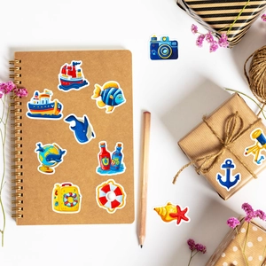 Close-up of nautical stickers on a notebook with blue whale and anchor patterns