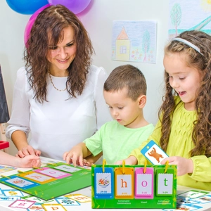 Children using educational phonics flashcards with green desktop stand for spelling practice
