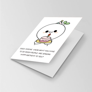 Detail of funny birthday card featuring a cute cartoon character and humorous quote