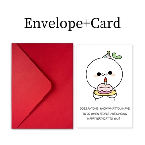 Detail showing a white birthday card with humor text and a matching red envelope set