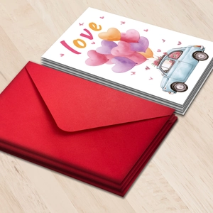 Detail of Valentine's card with red envelope and love theme on wood background