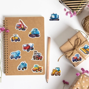 Construction vehicle stickers applied on a kraft notebook and gift box in a clean setting