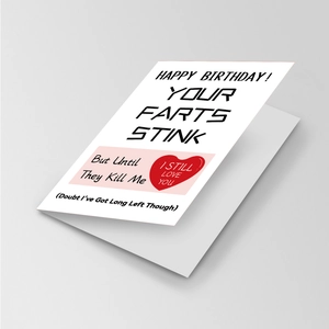 Detail shot of humorous white greeting card with bold black text and a small red heart icon