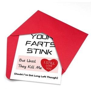 Top view of funny greeting card with humorous typography and matching red envelope