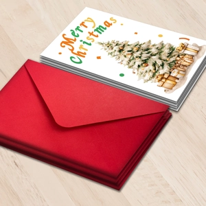 Gros plan de cartes de Noël avec motifs d'arbres festifs et enveloppes rouges sur bois