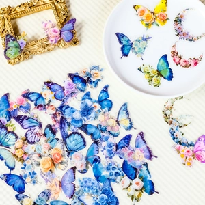 Detailed view of floral and butterfly PET stickers on a textured background with golden frame