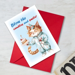 Détail de carte d'anniversaire chat avec enveloppe rouge sur fond marbre