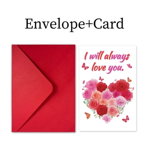 Close-up of heart-shaped rose pattern greeting card with red envelope and romantic quote