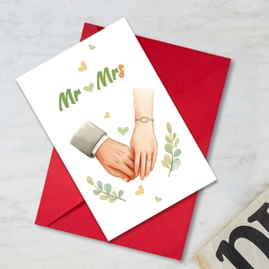 Wedding card with Mr & Mrs illustration and red envelope on marble background
