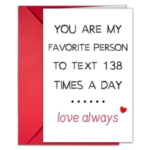 Detail showing humorous text on minimalist white card with vibrant red envelope