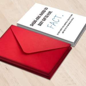 Flat lay of Father's Day greeting cards with blue text and vibrant red envelopes