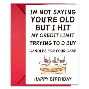 Macro shot of humorous birthday card with colorful cake illustration and red envelope