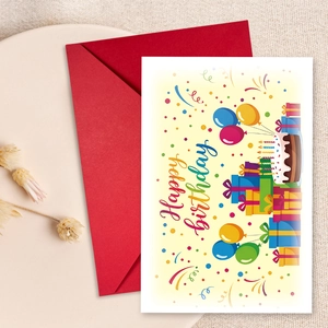 Detail view of Happy Birthday card with colorful cake and red envelope on linen