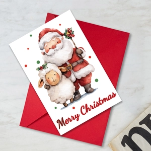 Détail d'une carte de Noël avec un Père Noël à l'aquarelle et enveloppe rouge