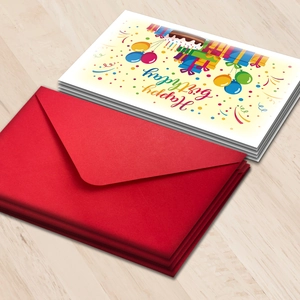 Close-up of birthday cards with colorful cake design and matching red envelopes