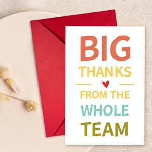Detailed view of white greeting card and red envelope on an elegant ceramic plate