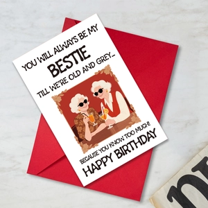 Flat lay of a funny birthday card with a red envelope on marble background
