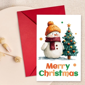 Close-up of watercolor snowman greeting card with a red envelope on a linen background