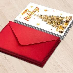 Close-up of Happy Holidays cards and red envelopes on a wooden texture background