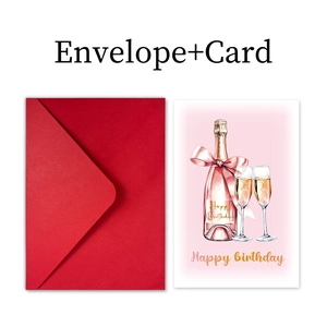 Close-up of birthday card set with pink champagne illustration and red envelope