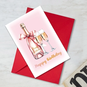 Macro detail of watercolor birthday card with champagne glasses and red envelope
