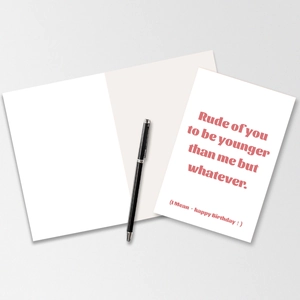 Macro detail of humor birthday card with red bold text on premium white paper with pen