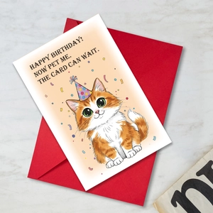 Detailed view of an orange tabby cat birthday card with a vibrant red envelope