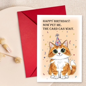 Detail of cute cat birthday card with a red envelope on a rustic textured background