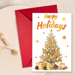 Detailed view of Christmas card with gold tree design and vibrant red envelope