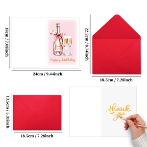 Macro view of birthday card set with champagne illustration and large red envelope