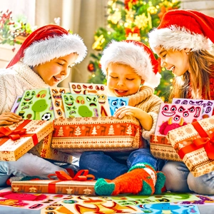 Close-up of three children playing with DIY cartoon dinosaur facial expression stickers