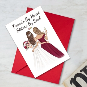 Detail of greeting card with Friends By Heart quote and red envelope on marble surface