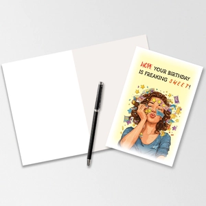 Pop art birthday card with colorful illustration and a black pen on a grey surface