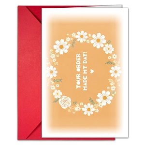 Detail view of floral thank you card with red envelope and daisy wreath design pattern
