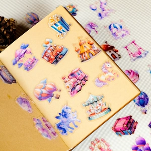 Detailed view of dreamy carousel and unicorn stickers on a notebook page for DIY journals