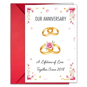 Detail showing an anniversary card with gold rings, roses, and a matching red envelope