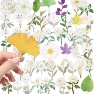 Detailed close-up of a hand holding a yellow leaf transparent PET sticker for journaling