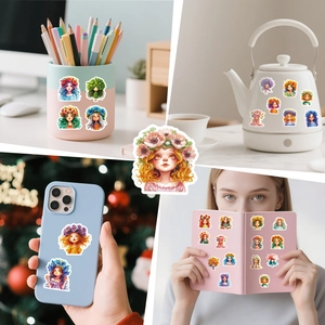 Close-up of cute floral girl stickers applied on laptop, phone case and water kettle