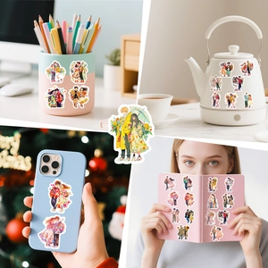 Detail showing decorative cartoon couple stickers applied on water bottles and phone cases
