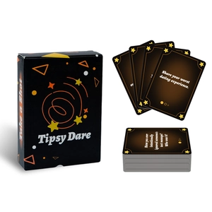 Close-up of Tipsy Dare party drinking game cards with social tasks and black gold design