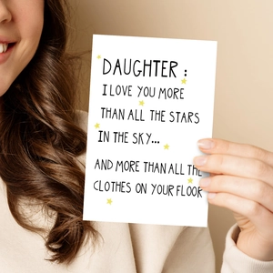 Close-up of a white greeting card for daughter with yellow stars and emotional message