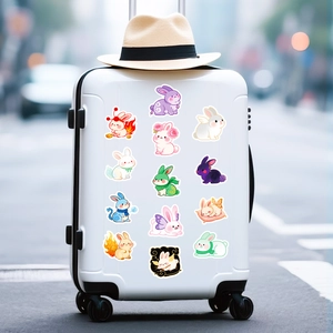 Detailed view of cute rabbit cartoon stickers applied on a white travel suitcase