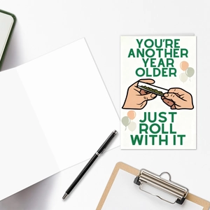 Flat lay of creative birthday card with envelope on office desk with pens