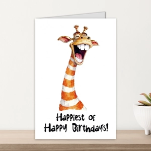 Detail of cute giraffe birthday card with envelope on a shelf with a white potted plant