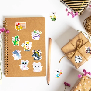Close-up of cute cartoon mouse stickers on a notebook with warm lifestyle props