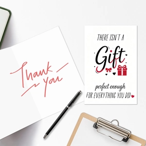Macro shot of minimalist thank you greeting cards and envelopes on a clean white desk