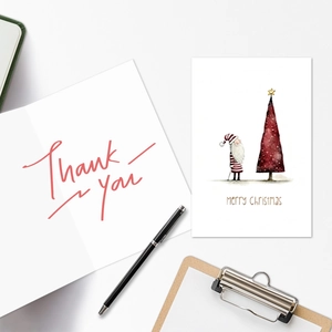 Detail showing vintage Christmas cards with Santa Claus and Thank You script on desk
