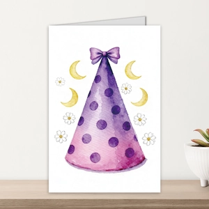 Detail of watercolor birthday card with purple polka dot party hat on a wooden table